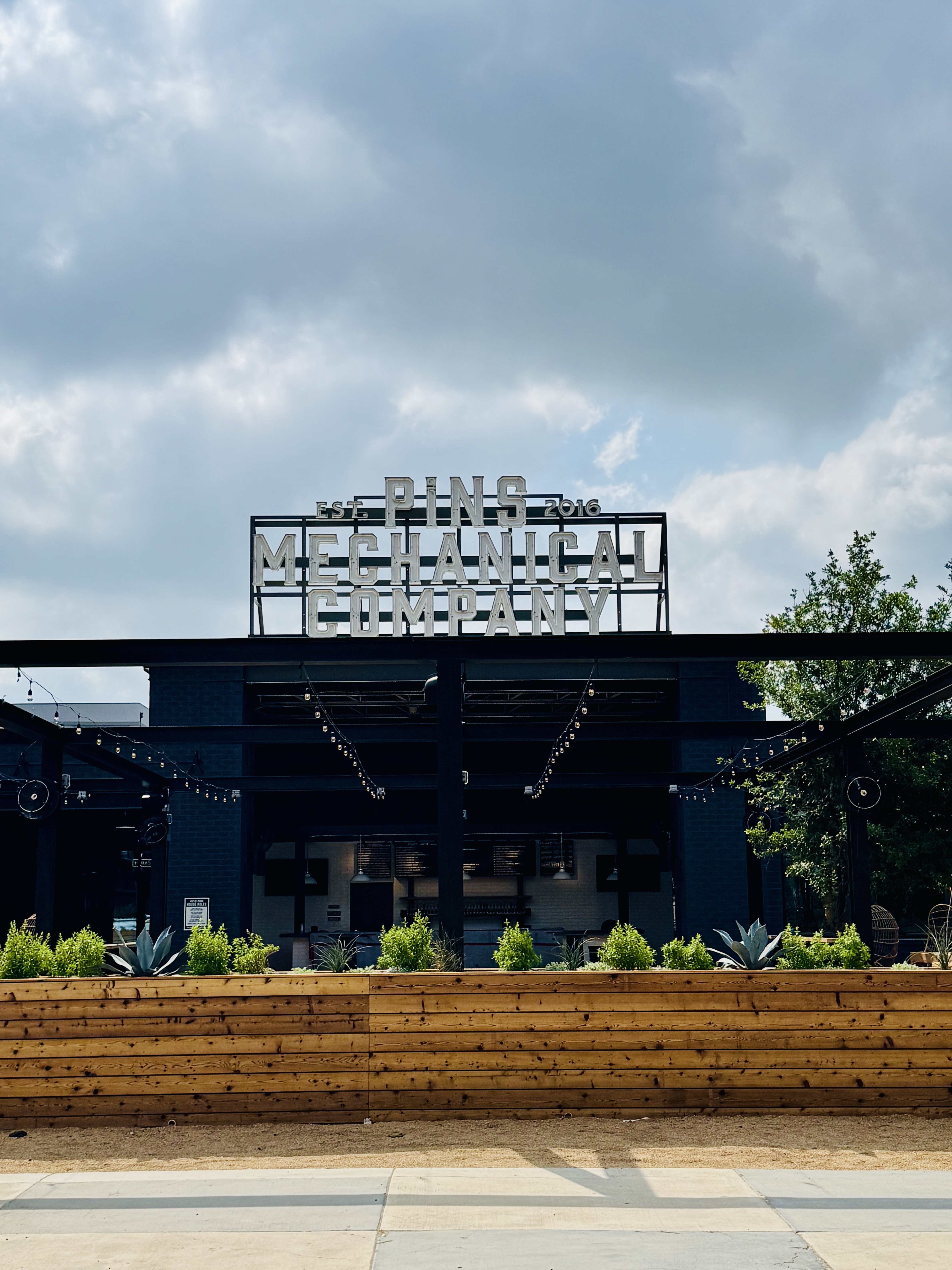 Frontal view of the planter row beneath the rooftop Pins Mechanical sign